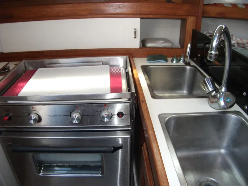 Slide: The Image of Galley kitchen in 1992 Catalina 30 MkII sailboat with stove and dual sinks. - 9