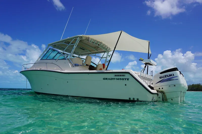 Slide: The Image of 2006 Grady-White Express 360 boat on clear turquoise water under a blue sky. - 0