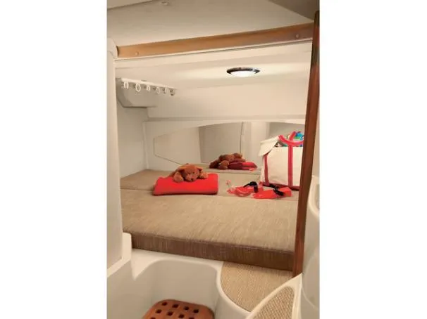 Slide: The Image of 2006 Grady-White Express 360 cabin interior with cozy bedding and plush toys. - 3