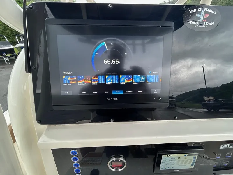 Slide: The Image of 2023 Skeeter SX 2250 boat dashboard with Garmin display showing navigation data. - 10