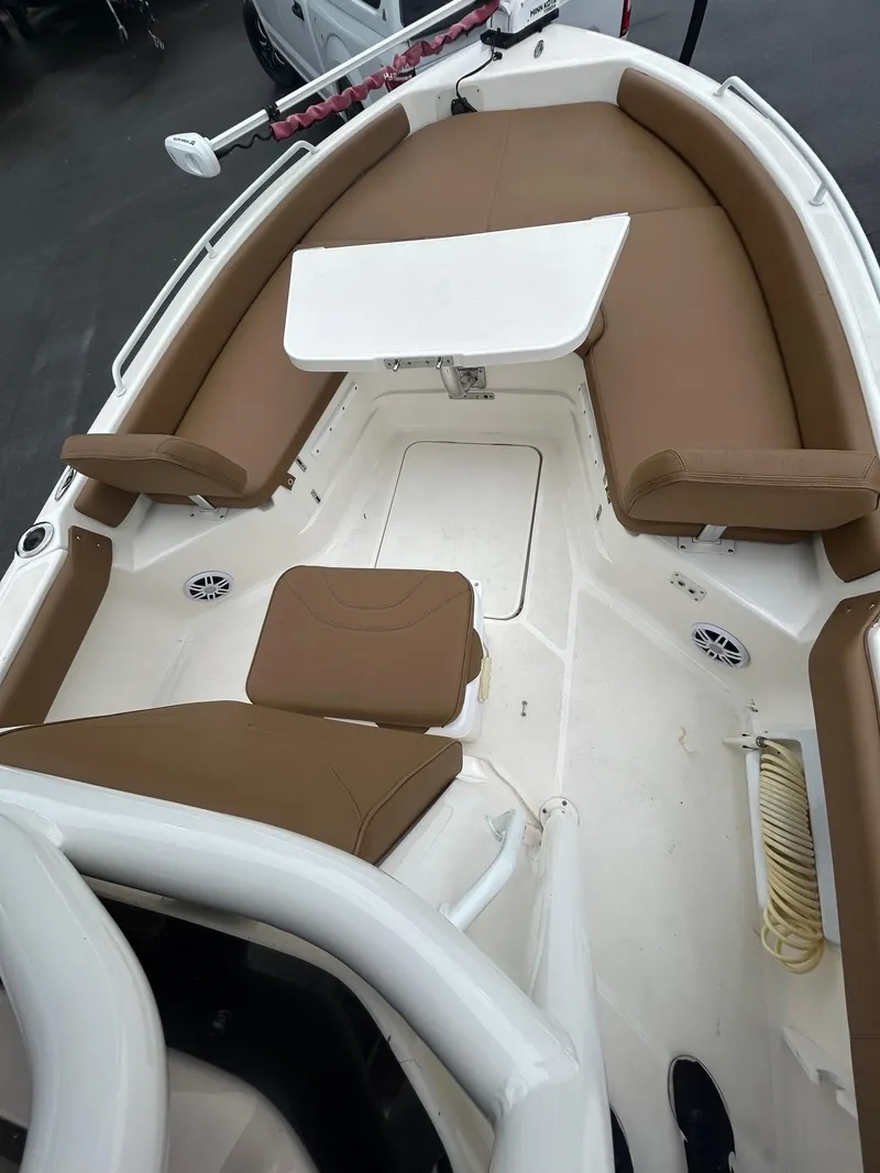 Slide: The Image of 2023 Skeeter SX 2250 boat interior with brown seating and white deck. - 14