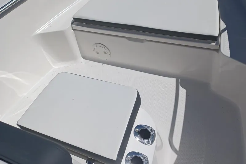 Slide: The Image of 2025 Robalo R160 Center Console boat seating area with cup holders. - 12