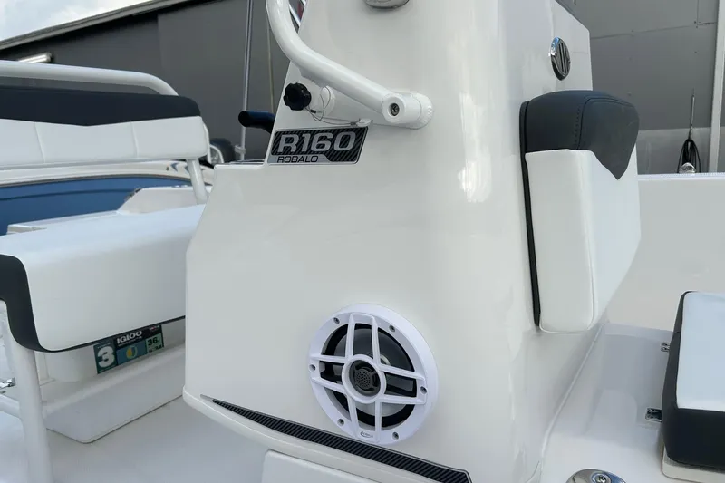 Slide: The Image of 2026 Robalo R160 Center Console boat interior with speaker and seating detail. - 13