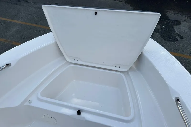 Slide: The Image of 2026 Robalo R160 Center Console boat storage compartment open on deck. - 17