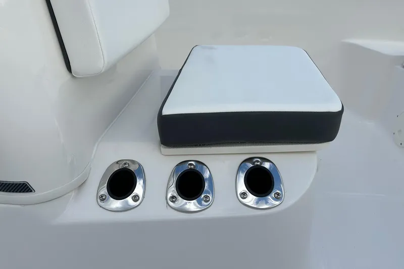 Slide: The Image of Robalo R160 Center Console 2026 boat seat with three rod holders. - 20