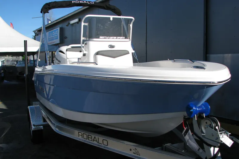 Slide: The Image of 2026 Robalo R160 Center Console boat on trailer, displayed outdoors. - 32