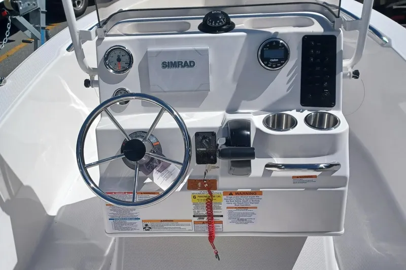 Slide: The Image of 2026 Robalo R160 Center Console with Yamaha 90 engine, parked on a trailer. - 4