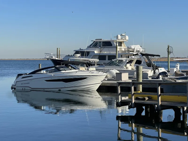 Slide: The Image of Luxury boats docked at marina, featuring 2023 Hussar 850 model. - 1