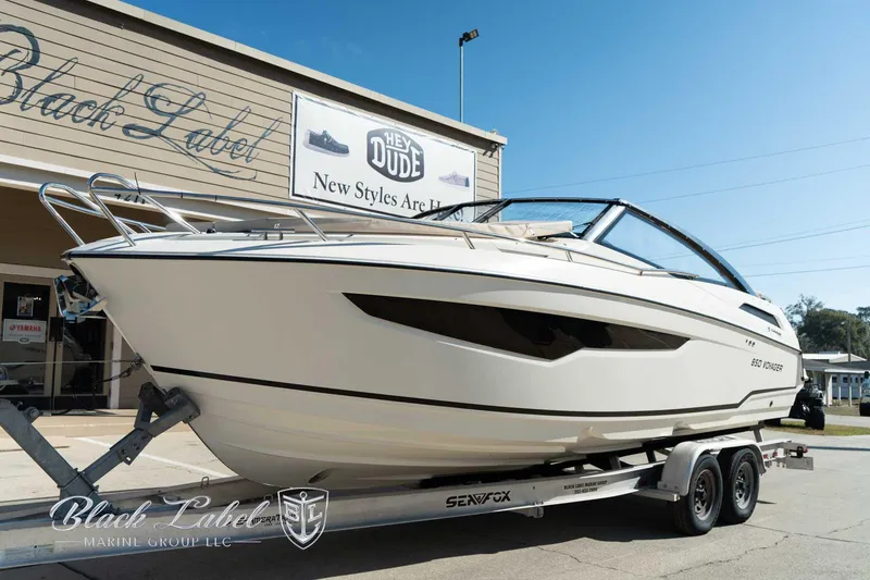 Slide: The Image of 2023 Hussar 850 boat on trailer outside Black Label Marine Group. - 11