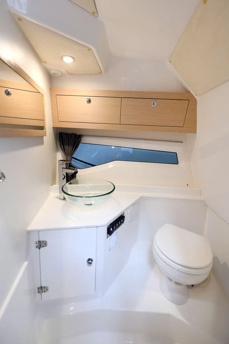 Slide: The Image of Modern bathroom interior in 2023 Hussar 850 boat, featuring sleek design and compact amenities. - 7