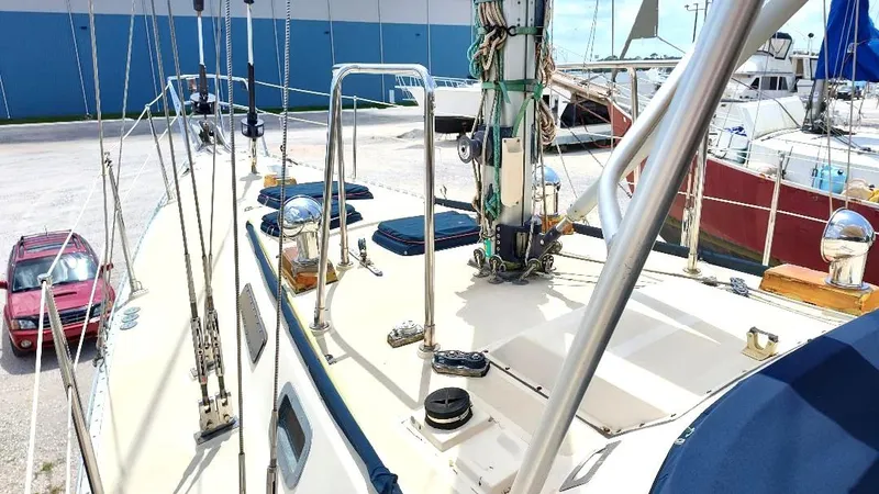 Slide: The Image of 1985 Tayana Vancover 42 sailboat deck with rigging, docked near other boats. - 11