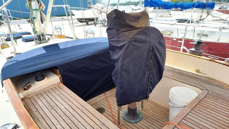 Slide: The Image of 1985 Tayana Vancover 42 sailboat cockpit with covered helm and wooden deck. - 17