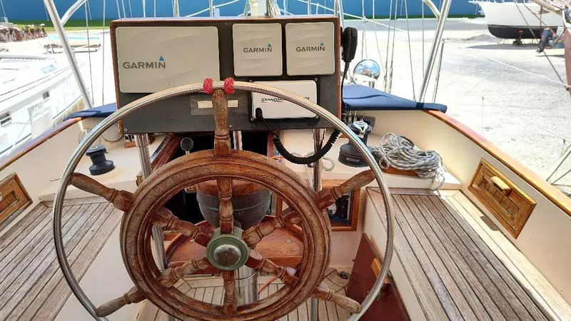 Slide: The Image of Wooden helm of 1985 Tayana Vancover 42 sailboat with Garmin navigation equipment. - 18