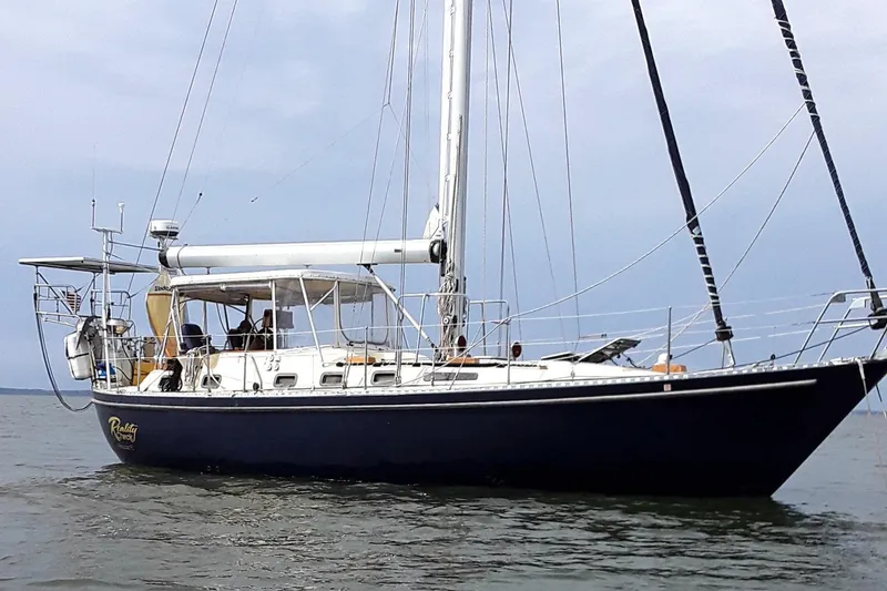 Slide: The Image of 1985 Tayana Vancover 42 sailboat on calm waters, side view. - 2
