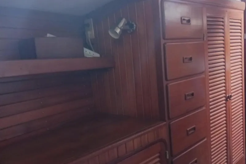 Slide: The Image of Interior of 1985 Tayana Vancover 42 yacht with wooden cabinetry and shelving. - 26