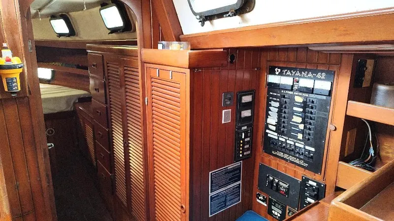Slide: The Image of Interior of 1985 Tayana Vancover 42 sailboat with wooden paneling and control panel. - 29