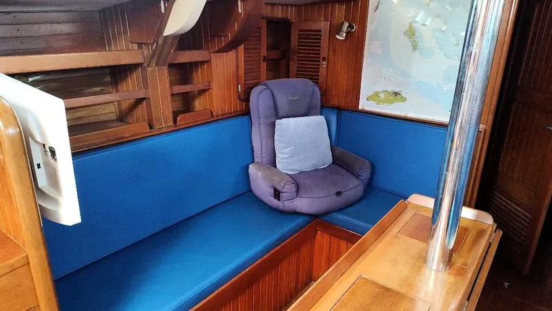 Slide: The Image of Cozy interior of 1985 Tayana Vancover 42 sailboat with blue seating and wooden finish. - 38