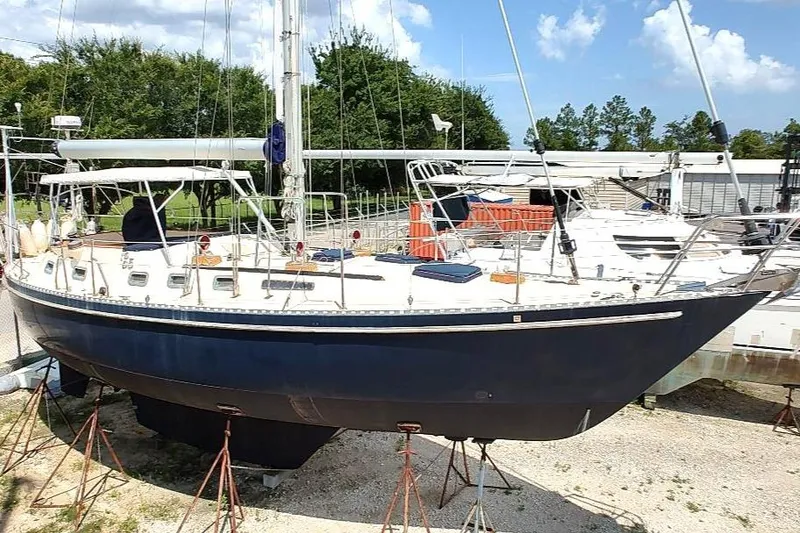 Slide: The Image of 1985 Tayana Vancover 42 sailboat on stands, blue hull, outdoor setting. - 4