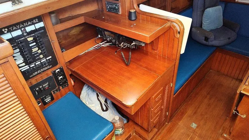Slide: The Image of 1985 Tayana Vancover 42 yacht interior with navigation station and wooden cabinetry. - 41