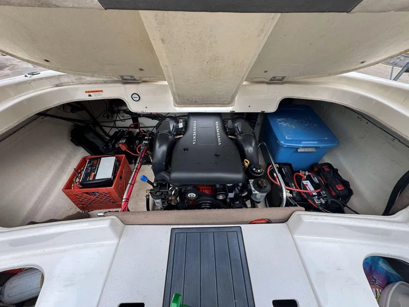 Slide: The Image of 2006 Glastron GX 235 engine compartment with battery and storage box. - 11