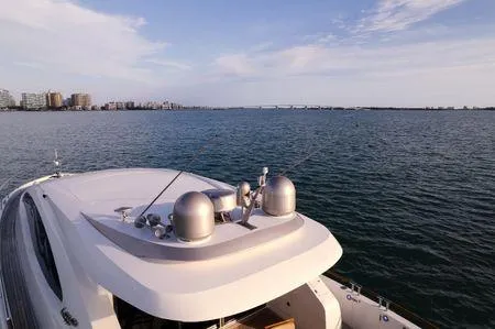 Slide: The Image of 2007 Lazzara LSX 75 yacht cruising on open water with city skyline in background. - 14
