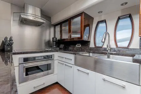 Slide: The Image of Modern kitchen in a 2007 Lazzara LSX 75 yacht with stainless steel appliances and sleek design. - 21