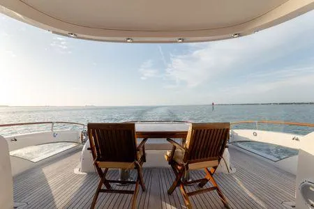 Slide: The Image of Luxury yacht deck view on a 2007 Lazzara LSX 75, featuring wooden chairs and ocean scenery. - 34