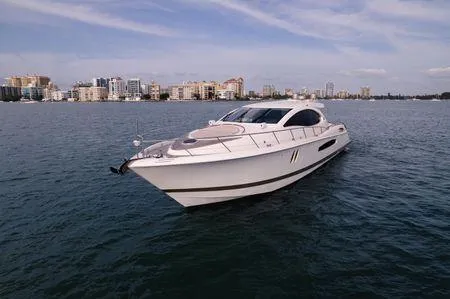 Slide: The Image of 2007 Lazzara LSX 75 yacht cruising on calm waters with city skyline backdrop. - 4