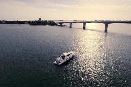 Slide: The Image of Aerial view of 2007 Lazzara LSX 75 yacht cruising near a bridge at sunset. - 7