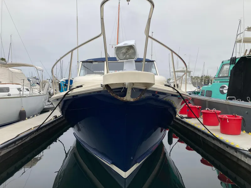 Slide: The Image of 2004 Mainship Pilot 34 boat docked at marina, front view. - 10