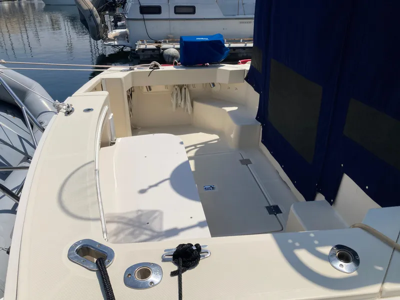 Slide: The Image of 2004 Mainship Pilot 34 boat deck with seating, docked at marina. - 11