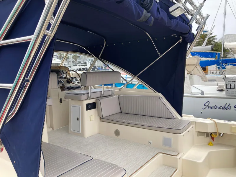 Slide: The Image of 2004 Mainship Pilot 34 boat interior with seating and canopy. - 14