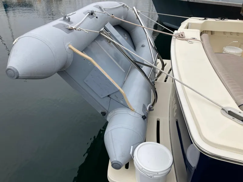 Slide: The Image of Inflatable dinghy secured on 2004 Mainship Pilot 34 boat's deck. - 17
