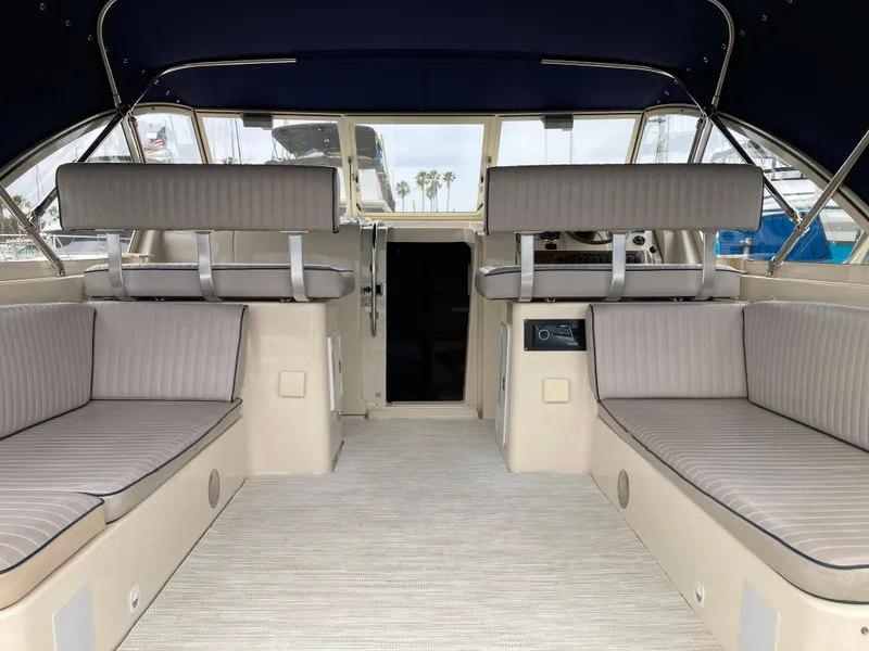 Slide: The Image of 2004 Mainship Pilot 34 interior with cushioned seating and spacious layout. - 18