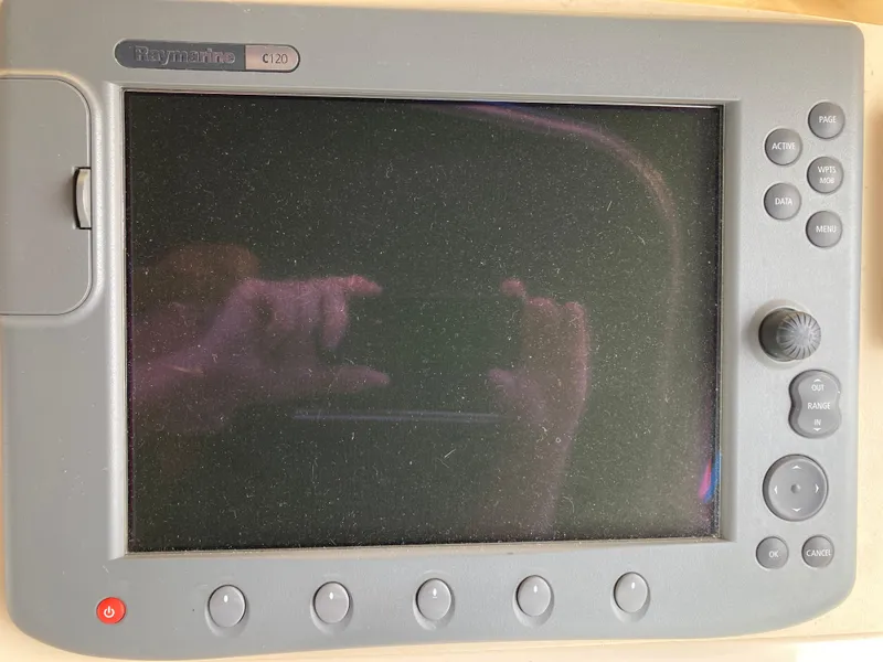 Slide: The Image of Control panel of a 2004 Mainship Pilot 34 boat, featuring various buttons and a display screen. - 27