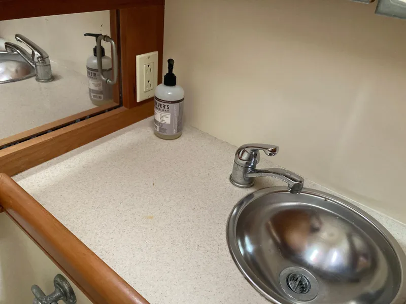 Slide: The Image of 2004 Mainship Pilot 34 bathroom sink with countertop and mirror. - 40