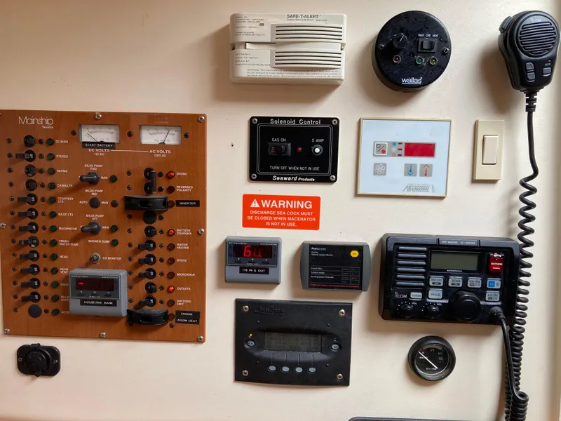 Slide: The Image of Control panel of a 2004 Mainship Pilot 34 boat with various gauges and switches. - 43