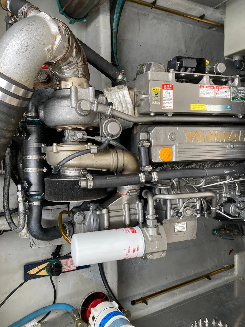 Slide: The Image of Engine compartment of a 2004 Mainship Pilot 34, featuring a Yanmar marine engine. - 47