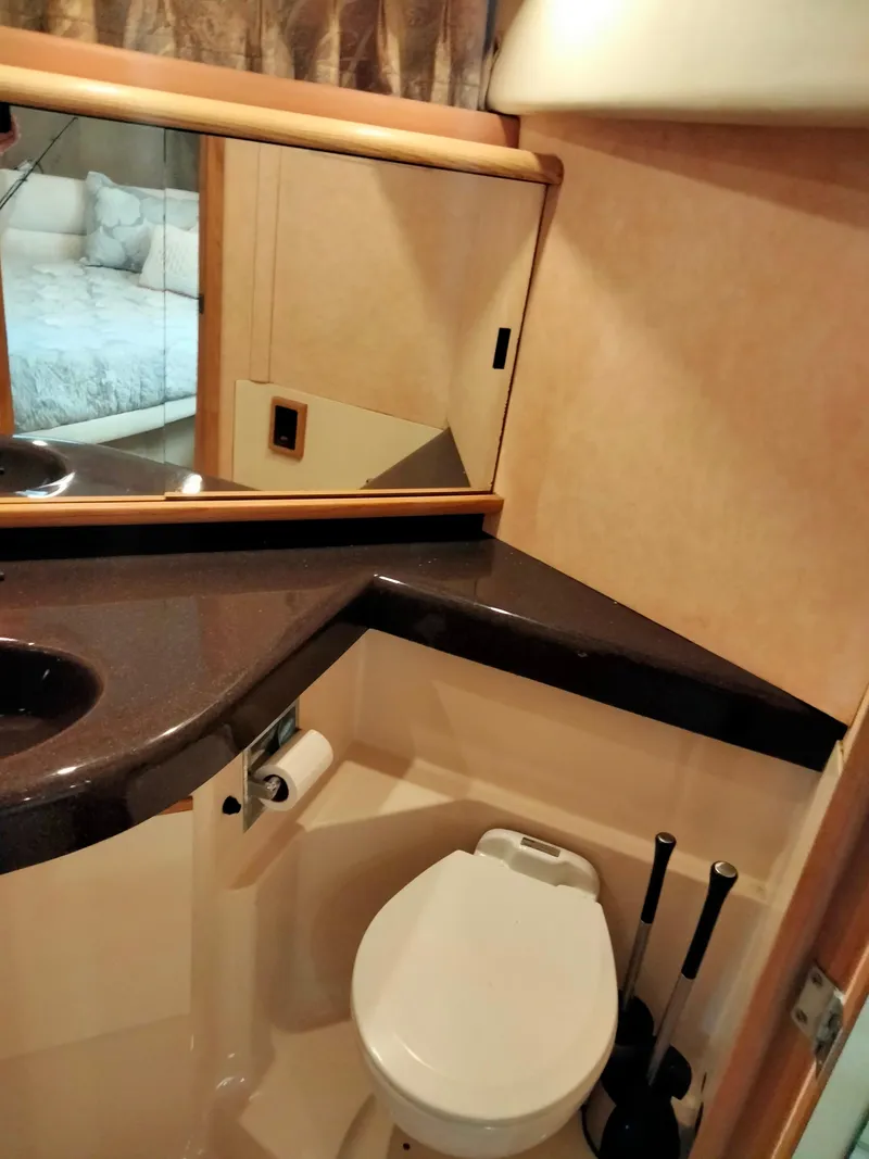 Slide: The Image of 1990 Bayliner 4387 Aft Cabin bathroom with modern fixtures and mirrored cabinet. - 19