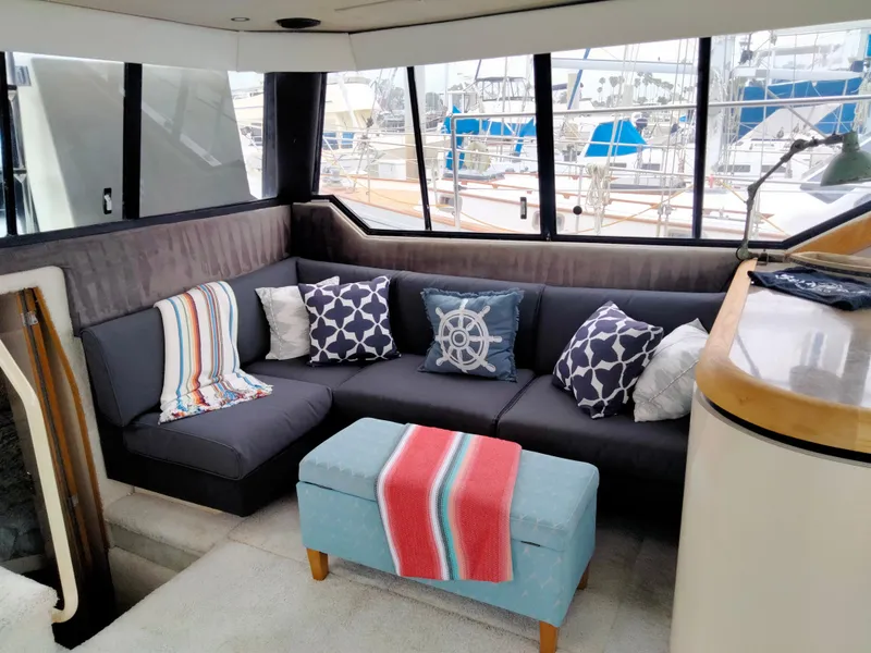 Slide: The Image of Interior of 1990 Bayliner 4387 Aft Cabin with cozy seating and nautical decor. - 22