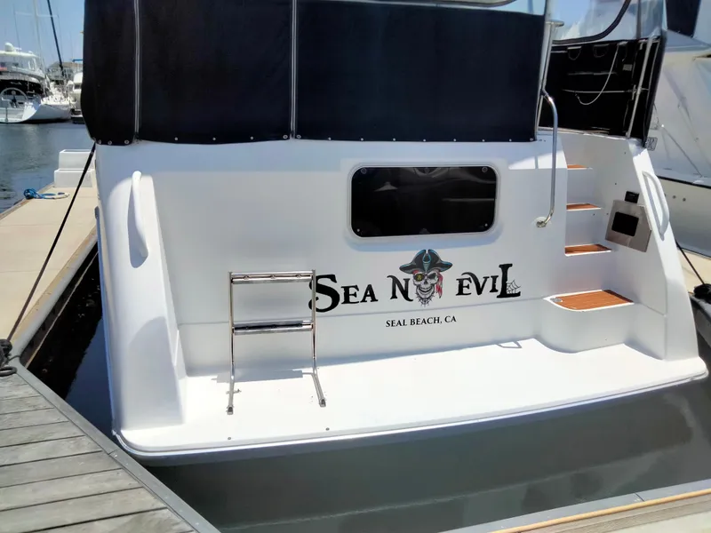 Slide: The Image of 1990 Bayliner 4387 Aft Cabin boat docked, featuring "Sea N Evil" name and Seal Beach, CA location. - 25