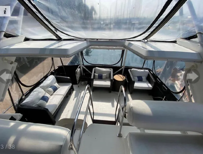 Slide: The Image of 1990 Bayliner 4387 Aft Cabin interior with seating area and clear canopy. - 5