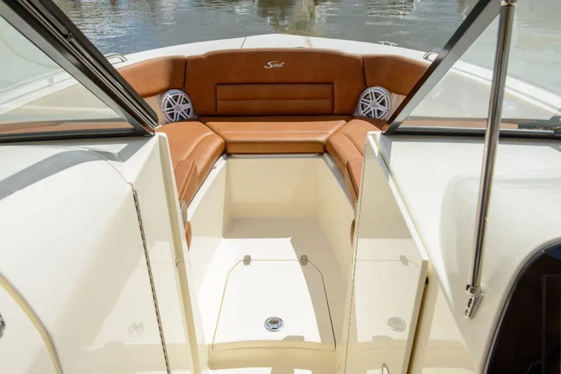 Slide: The Image of 2020 Scout 255 Dorado boat interior with Garmin navigation system and beige seating. - 5