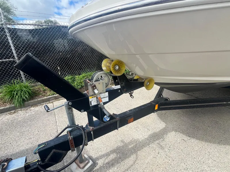 Slide: The Image of 2004 Sea Ray 220 Sundeck boat on trailer, parked outdoors. - 12