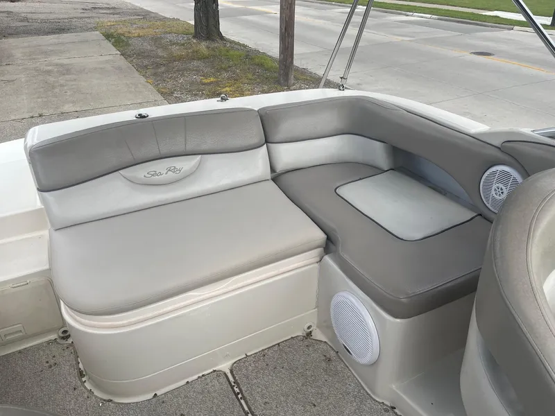 Slide: The Image of 2004 Sea Ray 220 Sundeck boat interior with gray seating and speaker. - 14