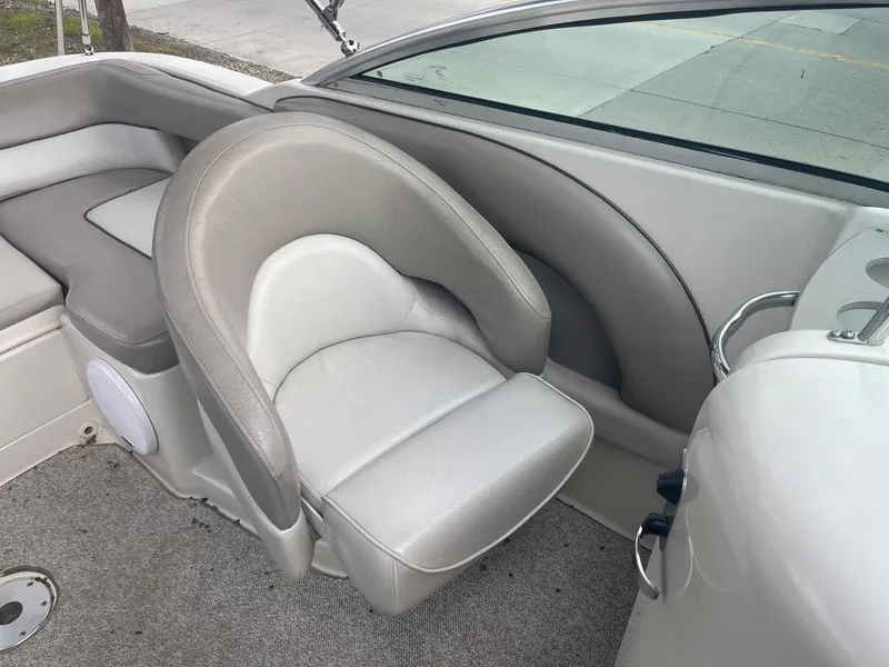 Slide: The Image of 2004 Sea Ray 220 Sundeck boat interior with cushioned seating and sleek design. - 15