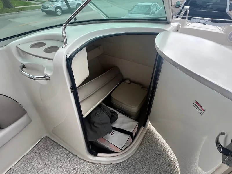 Slide: The Image of 2004 Sea Ray 220 Sundeck interior storage compartment with seating and accessories. - 16
