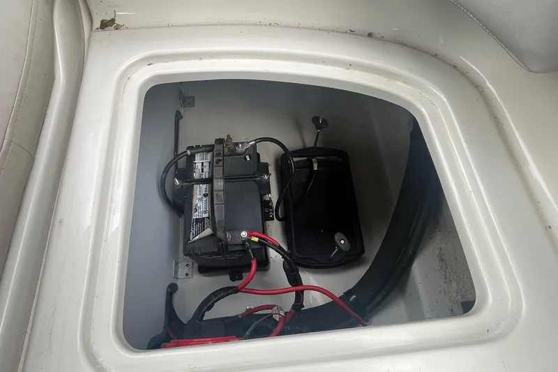 Slide: The Image of Battery compartment of 2004 Sea Ray 220 Sundeck boat, featuring wiring and components. - 23