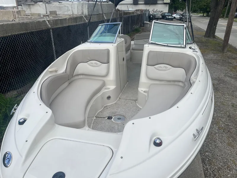 Slide: The Image of 2004 Sea Ray 220 Sundeck boat with spacious seating and open deck design. - 3