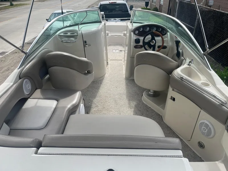 Slide: The Image of 2004 Sea Ray 220 Sundeck interior with seating, steering wheel, and dashboard. - 5
